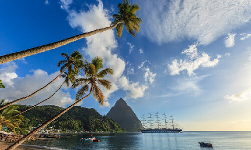 Magnificent sailing ship moored in the Soufrière Bay, on the southwest coast of Saint Lucia. Founded by the French in 1746, Soufrière was the first town of the island. In the background stands the imposing bulk of the Petit Piton, 743 meters high, one of the two twin volcanic plugs that are the natural landmark of the island.