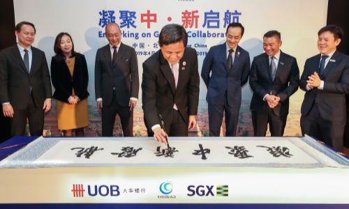 Chan Chun Sing puts the finishing touches on the calligraphy at MOU signing